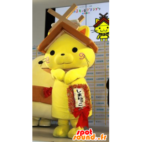 Mascote gato amarelo com um telhado da casa sobre sua cabeça - MASFR20595 - mascotes Casa