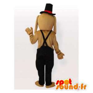 Beige hundemaskot med sort overall og hat - Spotsound maskot