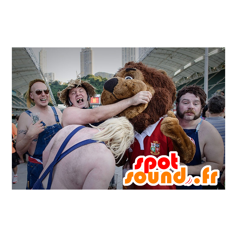 Brun lejonmaskot, alla håriga, i röda sportkläder - Spotsound Brun lejonmaskot, alla håriga, i röda sportkläder - Spotsound
