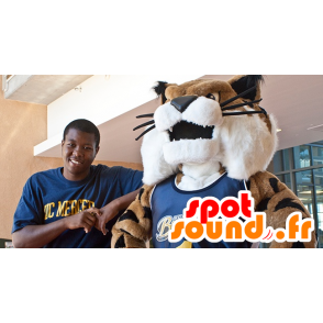 Vit, brun och svart kattmaskot i sportkläder - Spotsound maskot