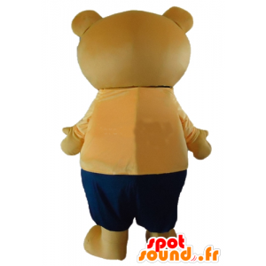 Stor beige nallebjörnmaskot i orange och blå outfit - Spotsound