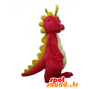 Lyserød og gul dinosaur maskot, smilende og farverig -