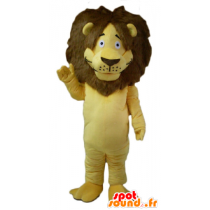 Maskottgult och brunt lejon, med en stor hårig man - Spotsound