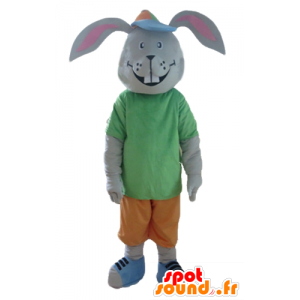 Grå kaninmaskot, smilende, med et farverigt tøj - Spotsound