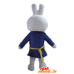 Hvid kaninmaskot, klædt i blåt, med forklæde - Spotsound maskot