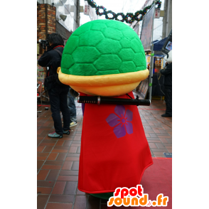 Mascot yellow and green turtle, red dress and purple - MASFR25123 - Yuru-Chara Japanese mascots