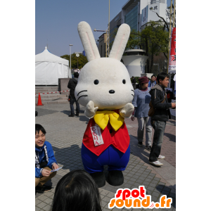Stor hvid kanin maskot, i gul, blå og rød tøj - Spotsound