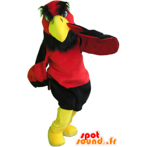 Rød og gul gribmascotte med sorte shorts - Spotsound maskot