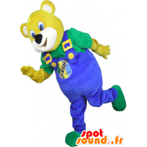 Gul björnmaskot, med blå overall - Spotsound maskot