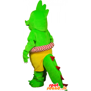 Prangende grøn dinosaur maskot i shorts med en bøje - Spotsound