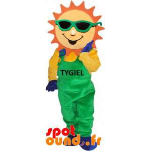 Klädd i grön overall för solmaskot - Spotsound maskot