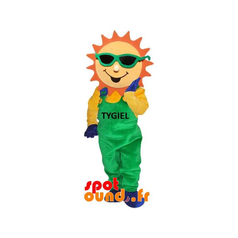 Klädd i grön overall för solmaskot - Spotsound maskot