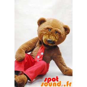 Brun bjørnemaskot med slips og røde bukser - Spotsound maskot
