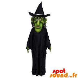 Grøn heksemaskot klædt i sort - Spotsound maskot