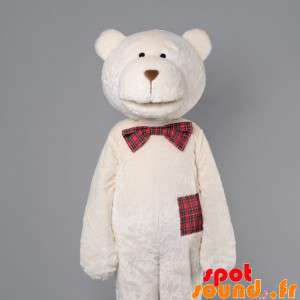 Beige teddy maskot med en...